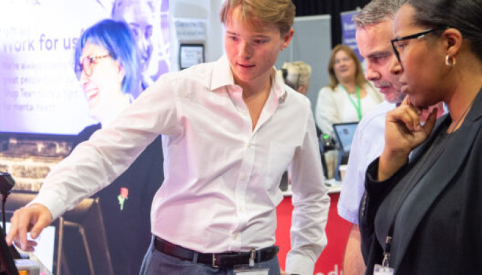 Exhibitor with clients at Conference
