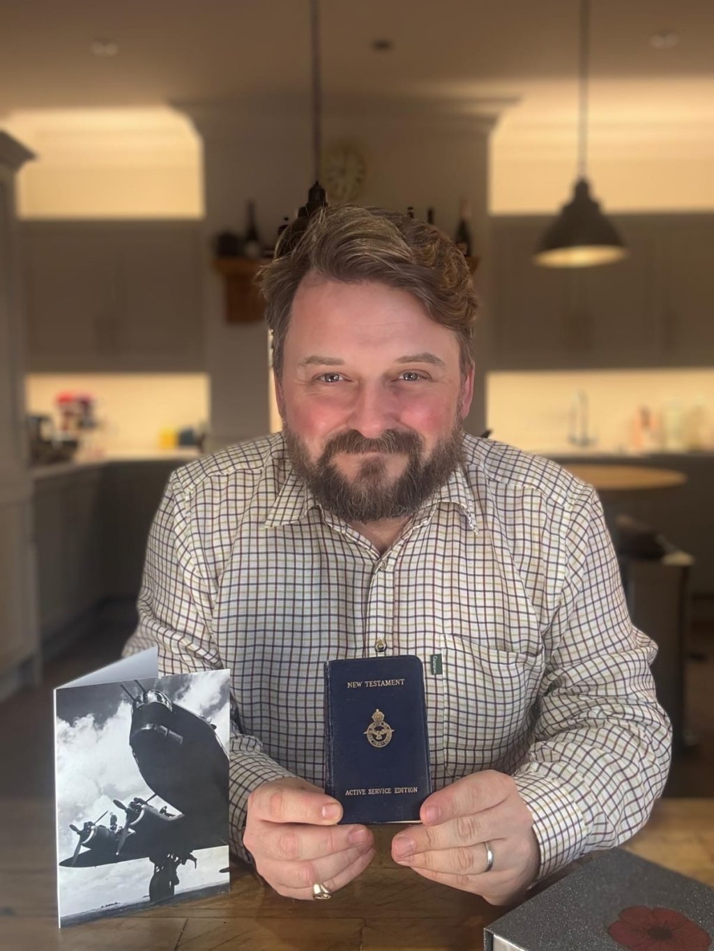 Man holding war-time bible.