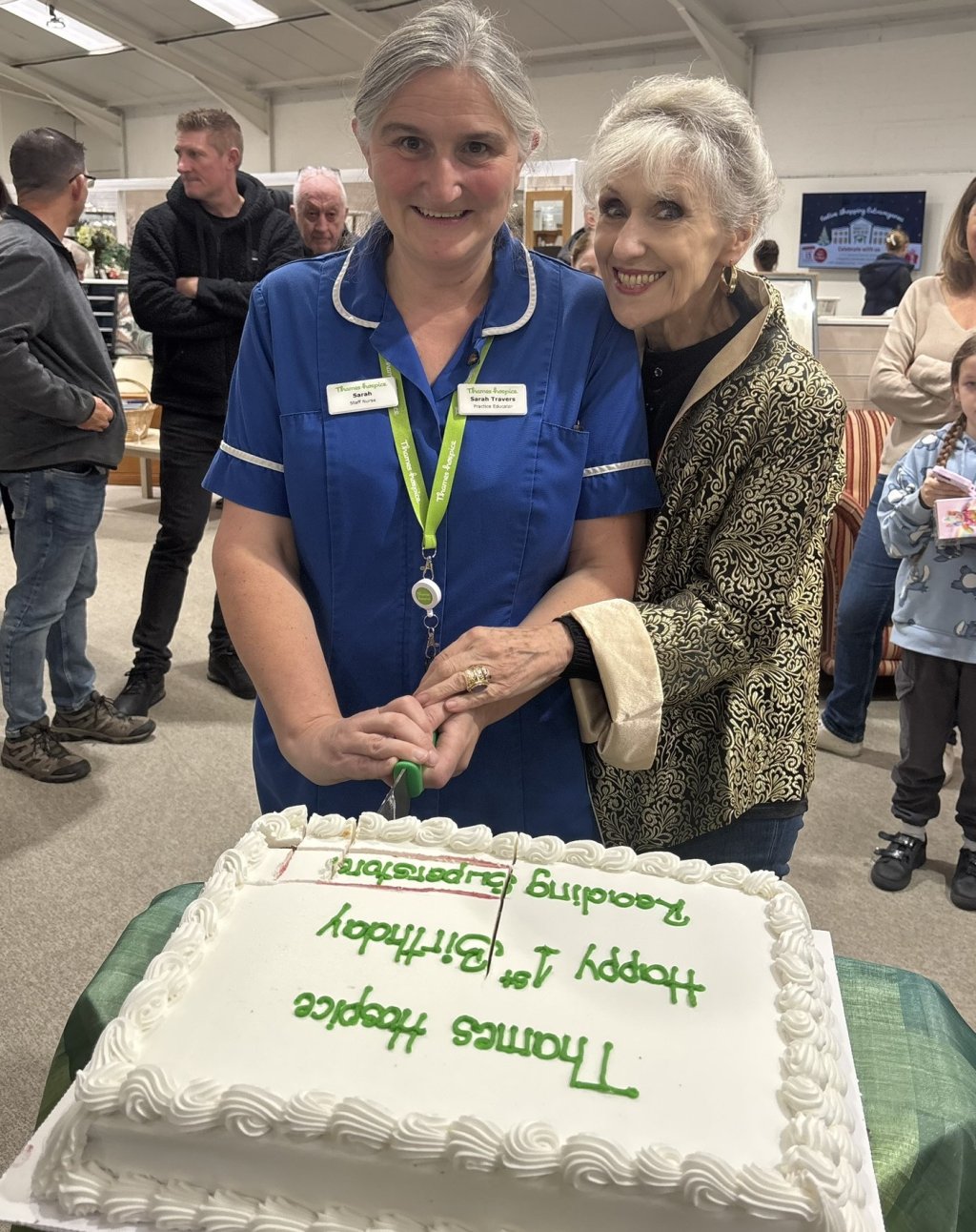 Anita Dobson cutting cake at Thames Hospice celebration.