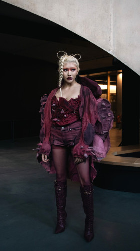 A women modelling a burgundy coloured outfit at the FARAxLCF event.