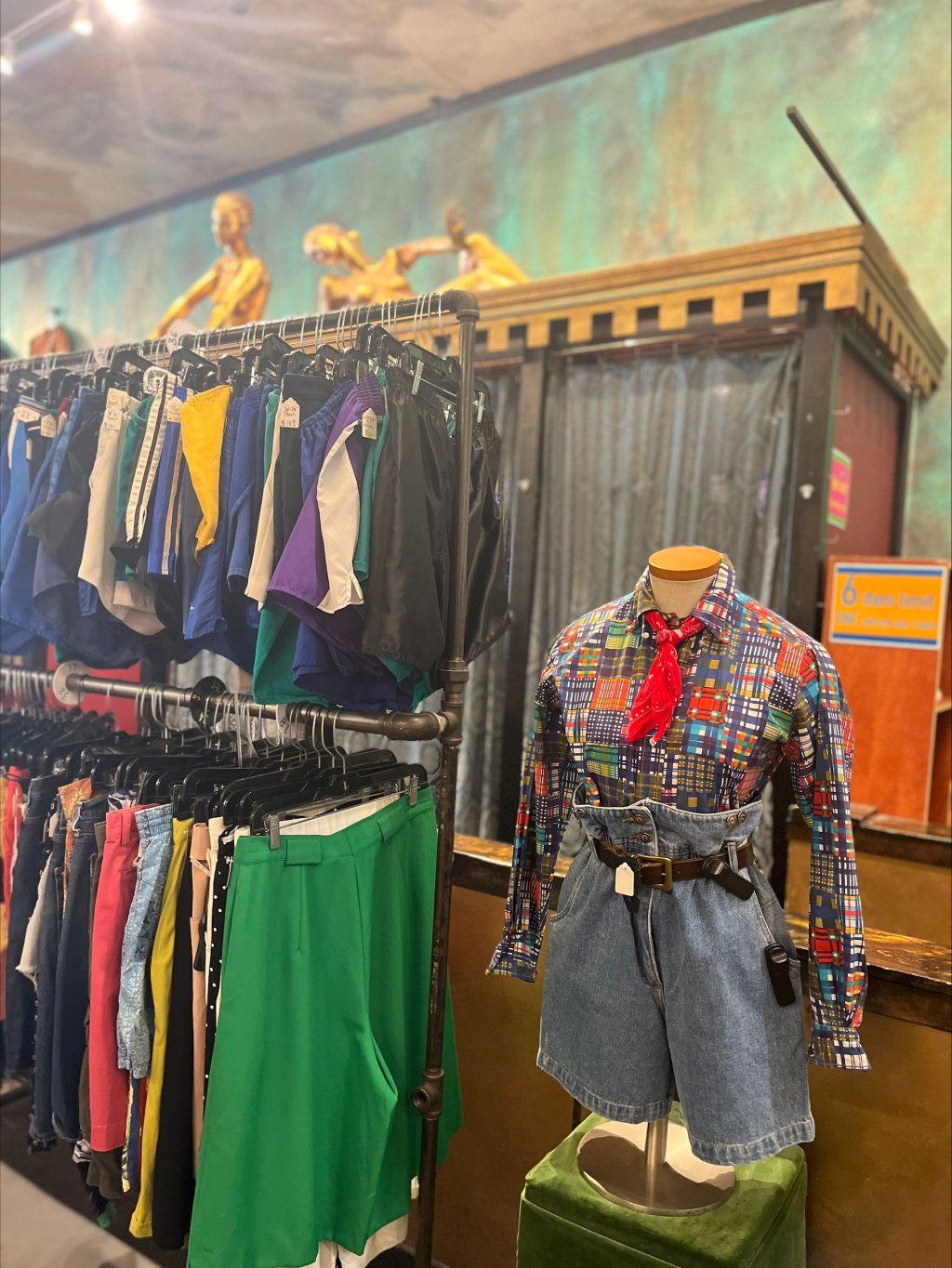 Brightly dressed mannequin and clothing.