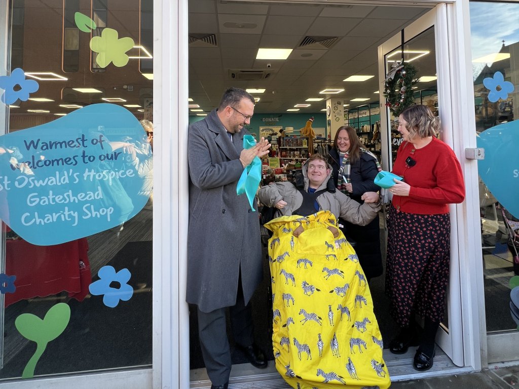 Charity shop opening and ribbon cutting.