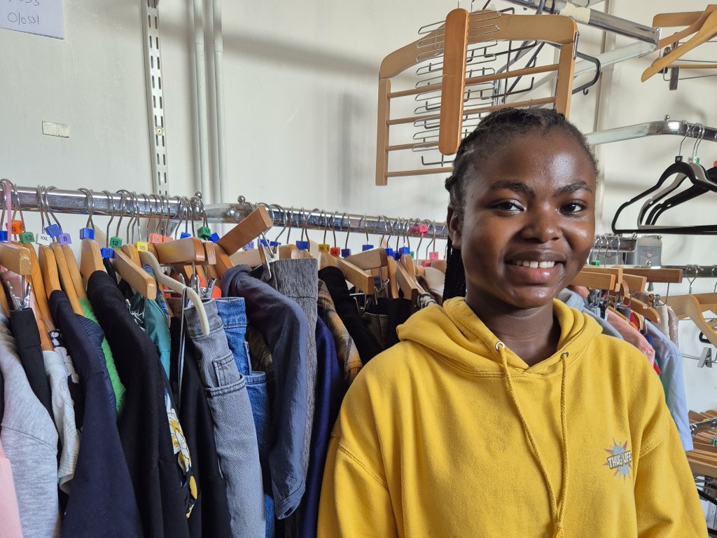 Young volunteer in back of shop.