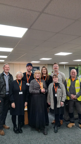 Award presentation taking place in office