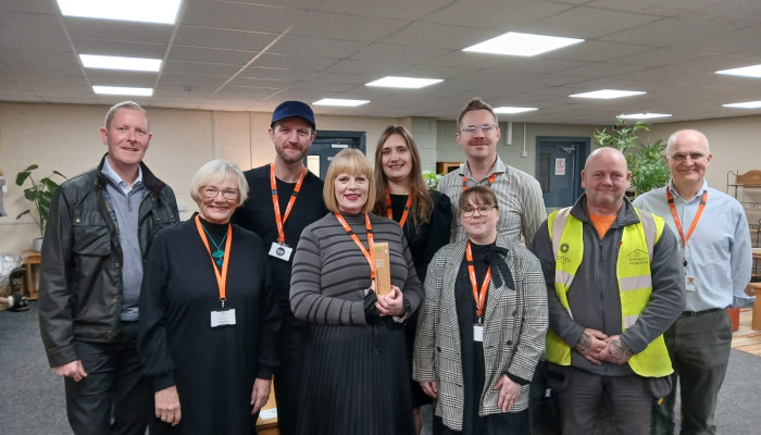 Award presentation taking place in office