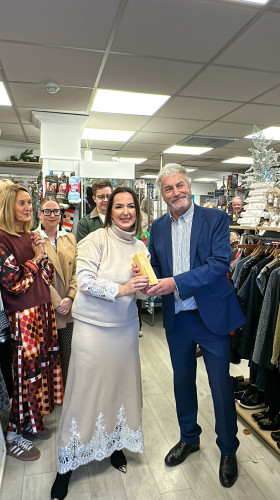 Award presentation taking place in shop