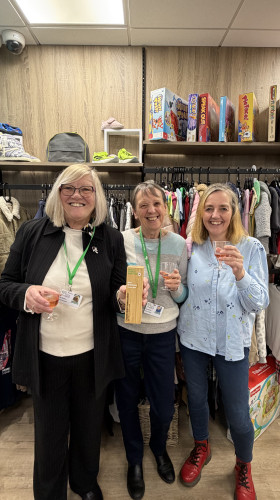 Charity retail team holding award