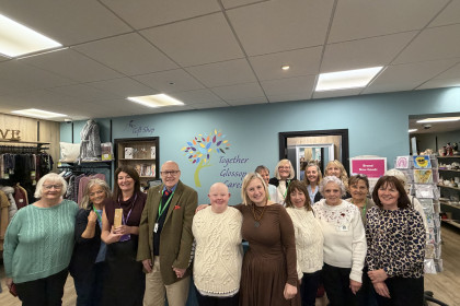 Charity retail team holding award