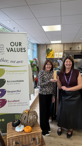 Charity retail team holding award