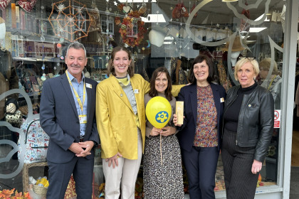 Charity shop team celebrate award win outside shop