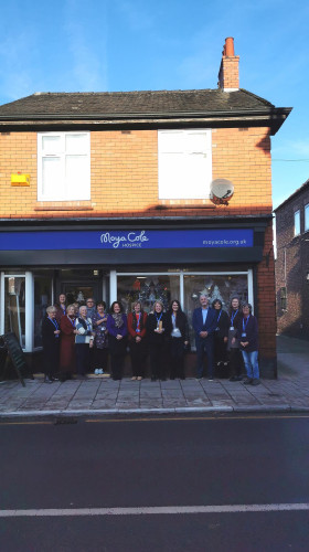 Moya Cole charity shop awards presentation group photo shop exterior